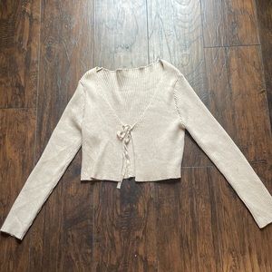 tie crème sweater